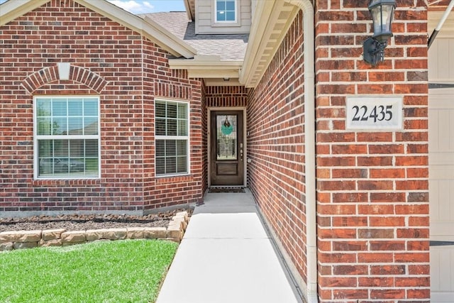 22435 Base Light Dr, Hockley, TX 77447 - doorway to property with brick siding and roof with shingles