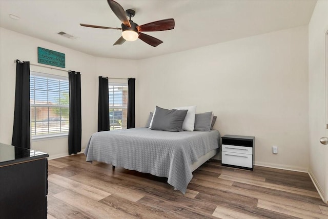 22435 Base Light Dr, Hockley, TX 77447 - bedroom featuring wood finished floors and ceiling fan