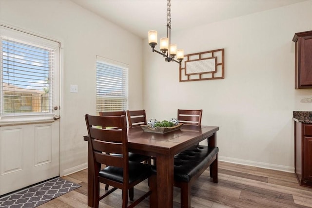 22435 Base Light Dr, Hockley, TX 77447 - dining area featuring light wood-style floors and a chandelier