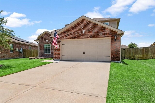 22435 Base Light Dr, Hockley, TX 77447 - traditional-style house featuring an attached garage, brick siding, and concrete driveway