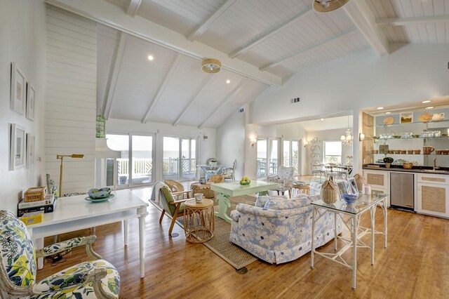 5113 Oleander St, Seabrook, TX 77586 - living area with light wood-type flooring, beam ceiling, high vaulted ceiling, a chandelier, and recessed lighting