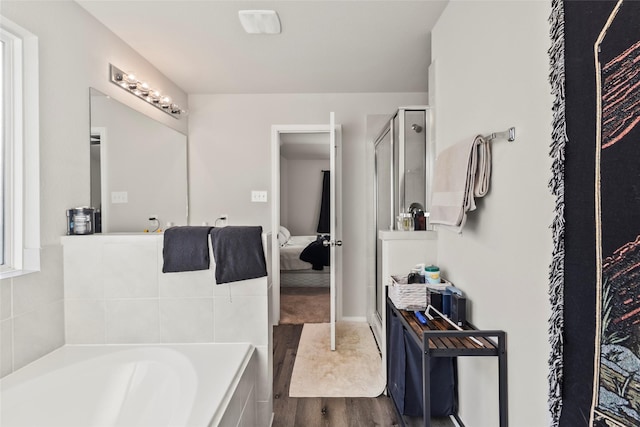4831 Blue Jacaranda Way, Spring, TX 77373 - bathroom featuring a garden tub, wood finished floors, a shower stall, and connected bathroom