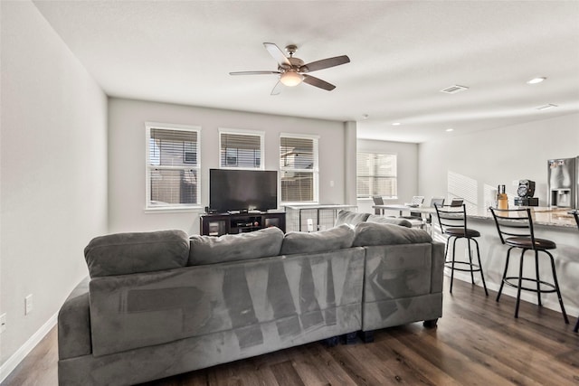 4831 Blue Jacaranda Way, Spring, TX 77373 - living area featuring a ceiling fan, dark wood-style floors, and baseboards