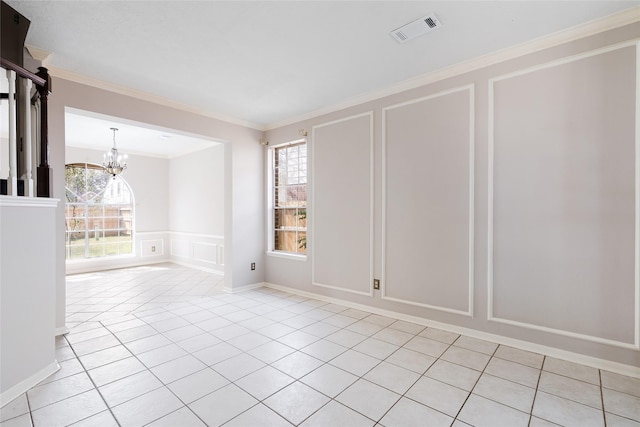 814 Hyacinth Pl, Missouri City, TX 77459 - empty room with a decorative wall, a chandelier, light tile patterned floors, crown molding, and a wainscoted wall