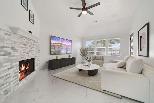 6519 Portlick Dr, Katy, TX 77449 - living room featuring marble finish flooring, a stone fireplace, a ceiling fan, and lofted ceiling