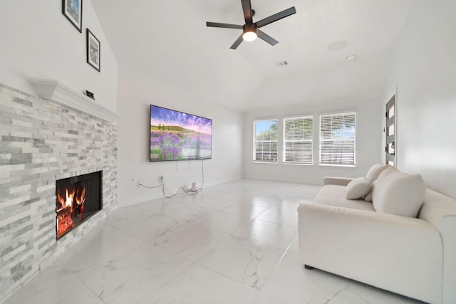 6519 Portlick Dr, Katy, TX 77449 - living area with a stone fireplace, vaulted ceiling, a ceiling fan, and light marble finish flooring