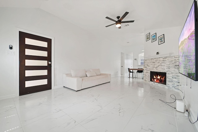 6519 Portlick Dr, Katy, TX 77449 - foyer featuring a ceiling fan, marble finish floors, vaulted ceiling, and a warm lit fireplace