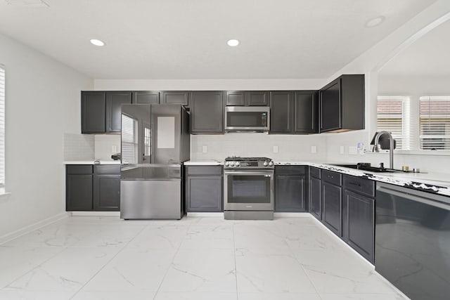 6519 Portlick Dr, Katy, TX 77449 - kitchen featuring stainless steel appliances, light marble finish floors, light countertops, decorative backsplash, and recessed lighting