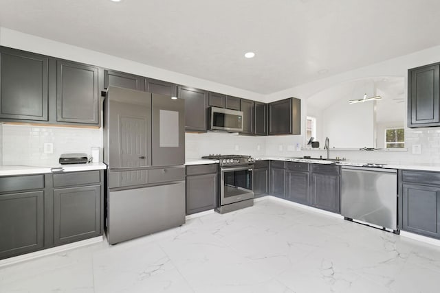 6519 Portlick Dr, Katy, TX 77449 - kitchen with stainless steel appliances, decorative backsplash, light countertops, recessed lighting, and light marble finish floors