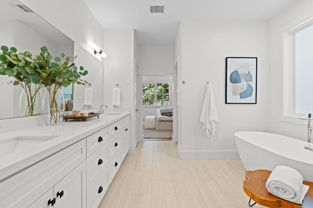 937 Louise St, Houston, TX 77009 - bathroom with double vanity, a freestanding bath, baseboards, and tile patterned floors