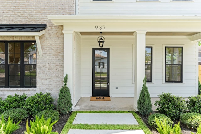 937 Louise St, Houston, TX 77009 - doorway to property with covered porch and brick siding