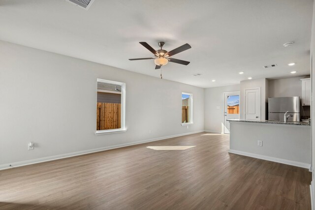 412 Tejas Trl, Waller, TX 77484 - unfurnished living room with a ceiling fan, baseboards, dark wood-style floors, and recessed lighting