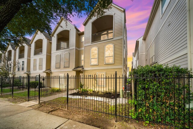 1918 Prospect St, Houston, TX 77004 - view of property with a balcony and a fenced front yard
