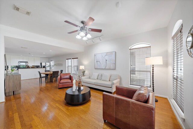 1918 Prospect St, Houston, TX 77004 - living room with light wood-style flooring, ceiling fan, and track lighting