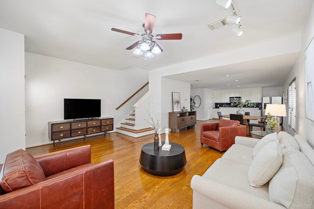 1918 Prospect St, Houston, TX 77004 - living room with stairs, light wood-type flooring, and ceiling fan