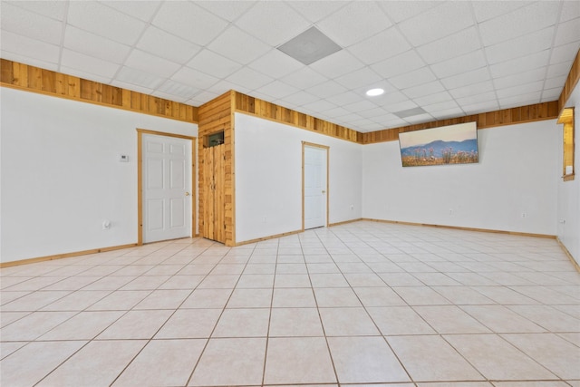 13236 Fm 1409 Unit A, Dayton, TX 77535 - unfurnished room featuring a drop ceiling, wooden walls, and baseboards