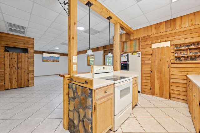 13236 Fm 1409 Unit A, Dayton, TX 77535 - kitchen with white appliances, wood walls, a paneled ceiling, light tile patterned flooring, and light countertops