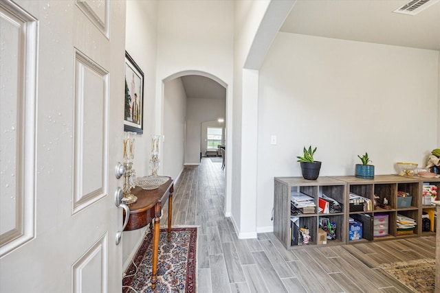 24214 Golden Fallow Dr, Katy, TX 77493 - entrance foyer with arched walkways, light wood-type flooring, and baseboards