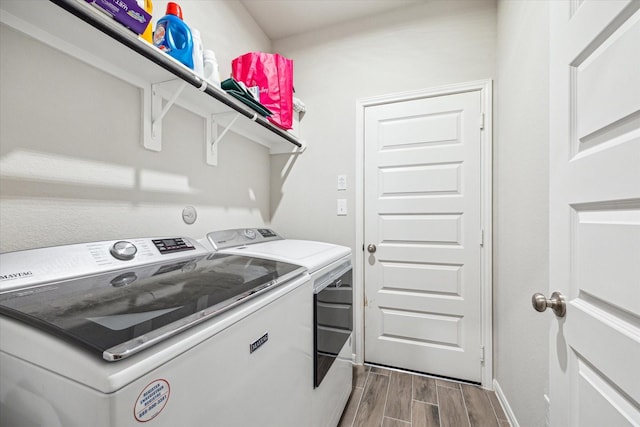 24214 Golden Fallow Dr, Katy, TX 77493 - laundry room featuring washing machine and clothes dryer, wood tiled floors, and baseboards