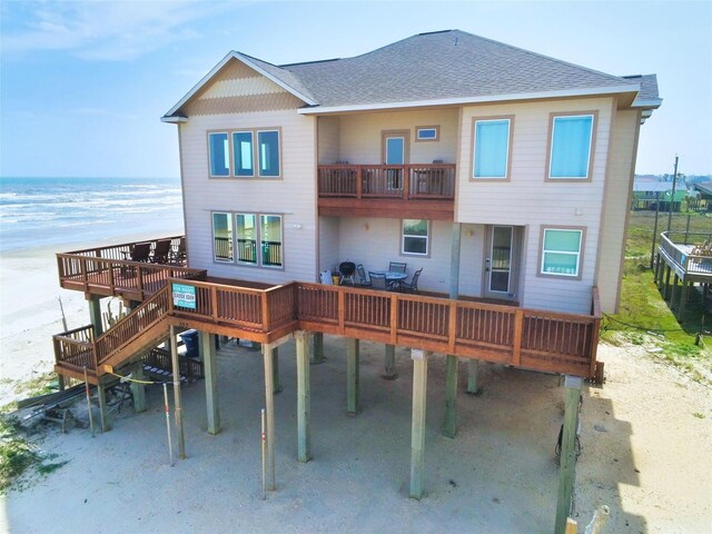 107 Yucca Ave, Surfside Beach, TX 77541 - rear view of property with roof with shingles, a balcony, and a deck with water view