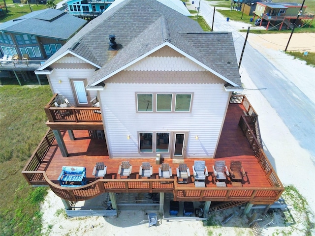 107 Yucca Ave, Surfside Beach, TX 77541 - back of house featuring roof with shingles and a deck