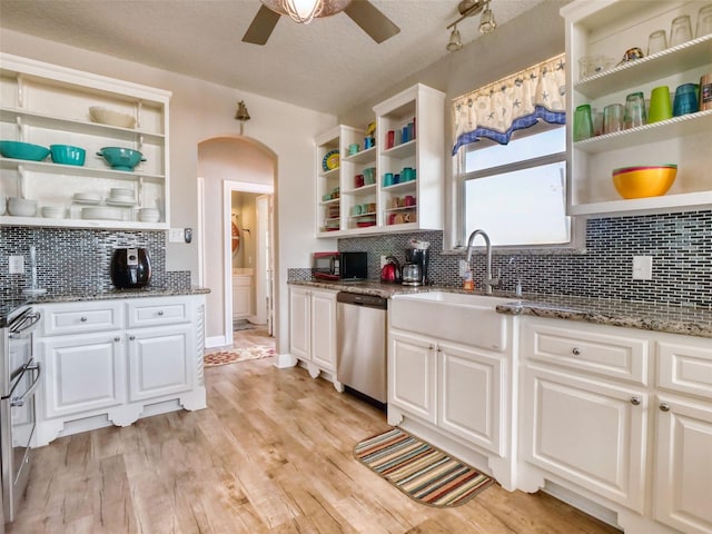 107 Yucca Ave, Surfside Beach, TX 77541 - kitchen featuring open shelves, stainless steel appliances, arched walkways, ceiling fan, and backsplash