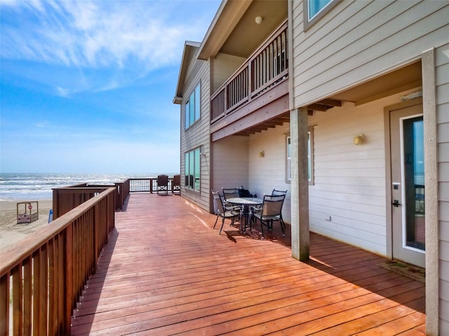 107 Yucca Ave, Surfside Beach, TX 77541 - wooden deck featuring outdoor dining space and view of water and beach
