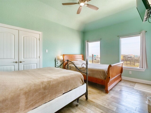 107 Yucca Ave, Surfside Beach, TX 77541 - bedroom with multiple windows, light wood finished floors, lofted ceiling, baseboards, and a ceiling fan