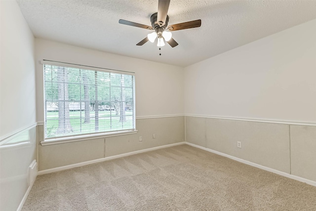 20731 Pin Oak Rd, New Caney, TX 77357 - carpeted spare room featuring a textured ceiling, a ceiling fan, and baseboards