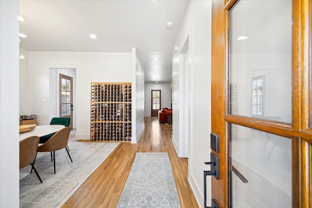 4731 Park Dr, Houston, TX 77023 - hallway with light wood finished floors, baseboards, and recessed lighting