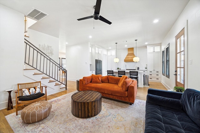 4731 Park Dr, Houston, TX 77023 - living area featuring light wood-style flooring, a ceiling fan, stairway, baseboards, and recessed lighting