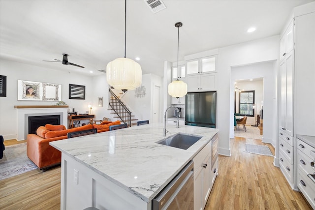 4731 Park Dr, Houston, TX 77023 - kitchen featuring appliances with stainless steel finishes, a sink, a ceiling fan, light wood-style floors, and recessed lighting