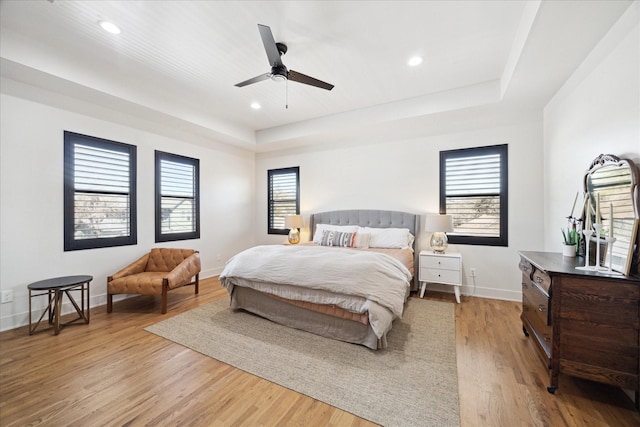 4731 Park Dr, Houston, TX 77023 - bedroom with a raised ceiling, baseboards, light wood-style floors, recessed lighting, and a ceiling fan