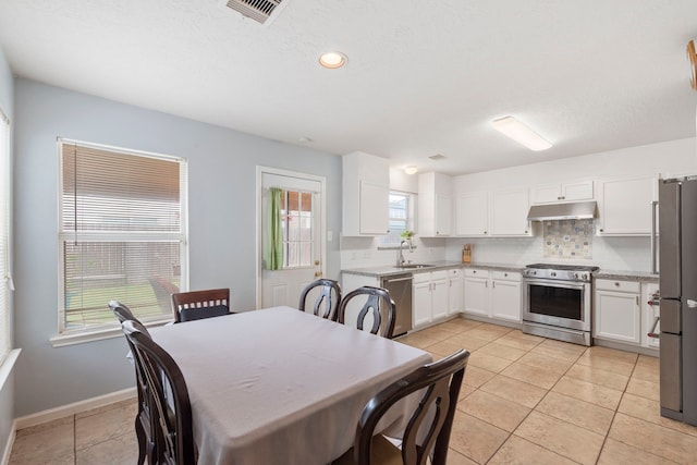 12007 Bach Orchard Trl, Houston, TX 77038 - dining space featuring light tile patterned floors, baseboards, and recessed lighting