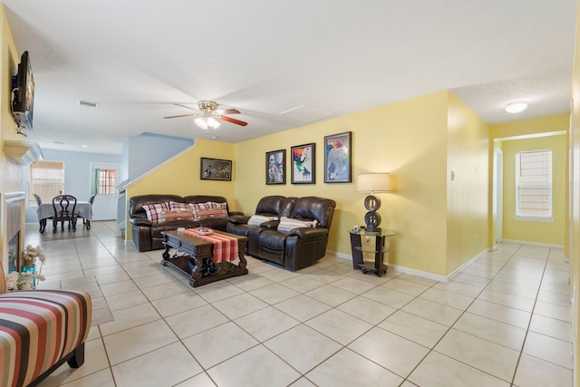 12007 Bach Orchard Trl, Houston, TX 77038 - living area featuring light tile patterned flooring, a ceiling fan, and baseboards