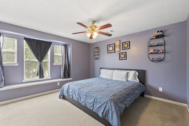 12007 Bach Orchard Trl, Houston, TX 77038 - bedroom with carpet floors, baseboards, a textured ceiling, and a ceiling fan