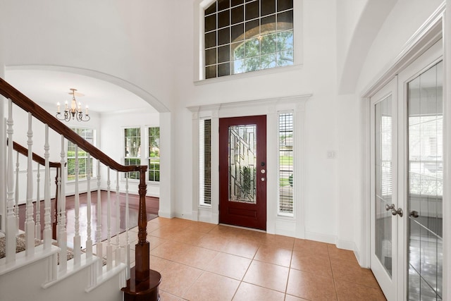 13202 Brushy Knoll Ln, Sugar Land, TX 77498 - tiled foyer with a high ceiling, stairs, healthy amount of natural light, a chandelier, and arched walkways