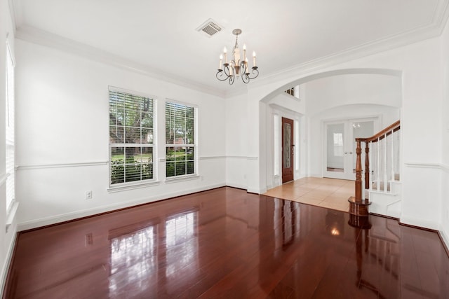 13202 Brushy Knoll Ln, Sugar Land, TX 77498 - empty room with arched walkways, ornamental molding, a chandelier, wood finished floors, and stairway