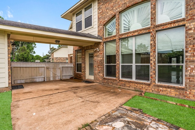 13202 Brushy Knoll Ln, Sugar Land, TX 77498 - exterior space with a gate, brick siding, and a patio