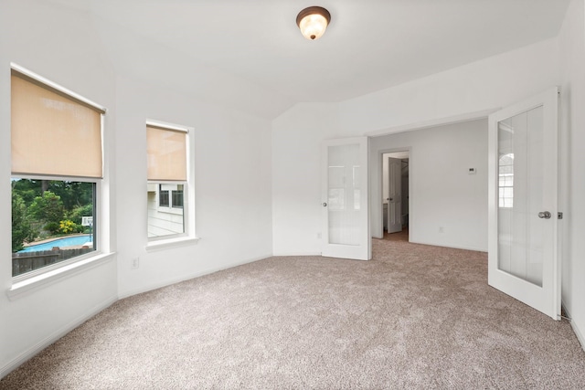 13202 Brushy Knoll Ln, Sugar Land, TX 77498 - carpeted spare room with french doors, baseboards, and lofted ceiling