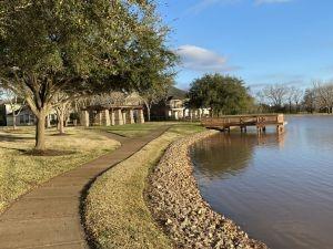 13202 Brushy Knoll Ln, Sugar Land, TX 77498 - view of home's community with a water view, a boat dock, and a lawn
