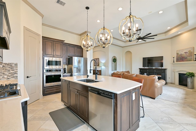 1530 Richland Hollow Ln, Friendswood, TX 77546 - kitchen with appliances with stainless steel finishes, a sink, a chandelier, arched walkways, and decorative backsplash