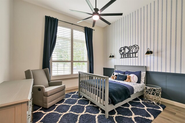 1530 Richland Hollow Ln, Friendswood, TX 77546 - bedroom with wood finished floors, wallpapered walls, wainscoting, and baseboards