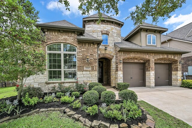 1530 Richland Hollow Ln, Friendswood, TX 77546 - french country home featuring driveway, stone siding, a garage, and brick siding