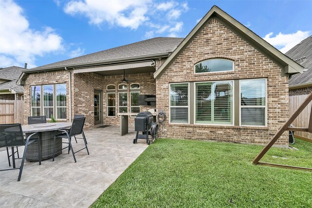 1530 Richland Hollow Ln, Friendswood, TX 77546 - back of house with brick siding, a ceiling fan, a patio, and a shingled roof