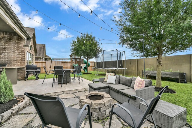 1530 Richland Hollow Ln, Friendswood, TX 77546 - view of patio / terrace with a trampoline, a grill, an outdoor living space with a fire pit, and a playground