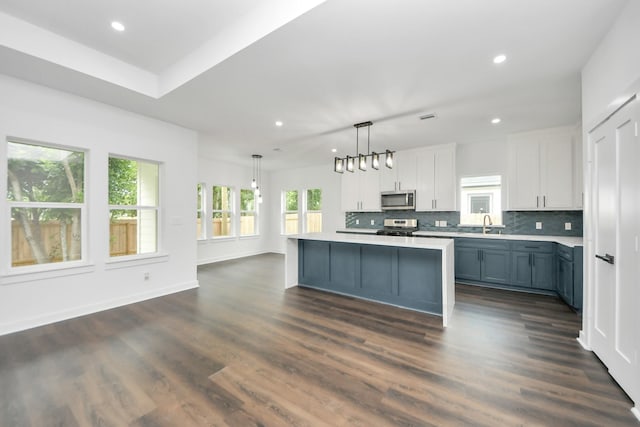 7440 Avenue E Ave E, Beasley, TX 77417 - kitchen featuring appliances with stainless steel finishes, recessed lighting, light countertops, decorative backsplash, and a center island