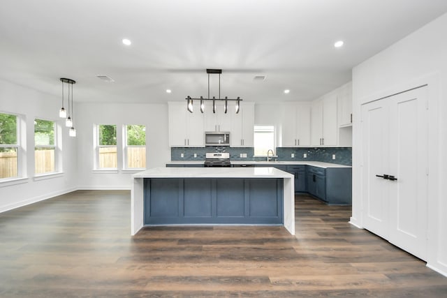 7440 Avenue E Ave E, Beasley, TX 77417 - kitchen featuring appliances with stainless steel finishes, white cabinetry, recessed lighting, a center island, and light countertops