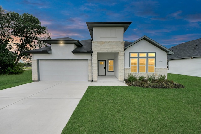 7440 Avenue E Ave E, Beasley, TX 77417 - modern home with stone siding, a yard, concrete driveway, an attached garage, and stucco siding