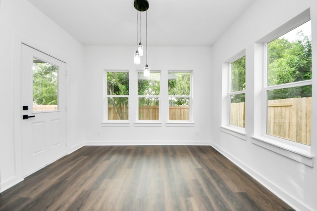 7440 Avenue E Ave E, Beasley, TX 77417 - unfurnished dining area with plenty of natural light, dark wood-style flooring, and baseboards